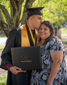 graduate in cap and gown with mother